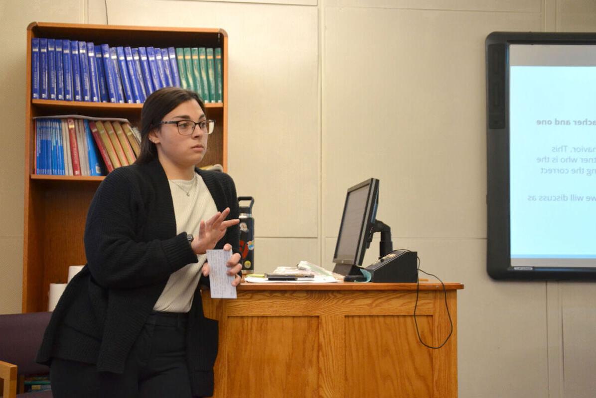 A student gives a presentation in an Education class